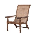 A MAURITIAN PLANTERS CHAIR, CIRCA 1900 the caned back and seat within a conforming frame, fold-out