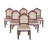 A SET OF SIX MAHOGANY UPHOLSTERED CHAIRS, 19TH CENTURY each arched carved top rail centred by a