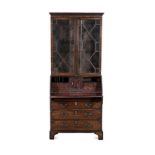 A GEORGE III MAHOGANY BUREAU BOOKCASE in two parts, the outswept cornice above a dentil frieze, a