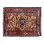AN AFGHAN CARPET, MODERN the gold field with a dark blue medallion, madder spandrels, all with