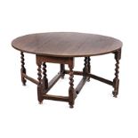 AN OAK GATE LEG TABLE, 18TH CENTURY the hinged oval top above a plain apron, barley-twist