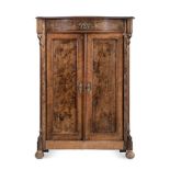 A CONTINENTAL WALNUT CUPBOARD, 20TH CENTURY the rectangular top above a long panelled frieze drawer,