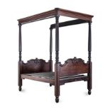 A VICTORIAN MAHOGANY FOUR-POSTER BED the carved and shaped head and foot board centred by a