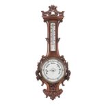 AN OAK ANEROID BAROMETER WITH THERMOMETER, EARLY 20TH CENTURY the carved oak base with floral