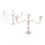 A PAIR OF AMERICAN SILVER THREE-LIGHT CANDELABRA, EMPIRE, 20TH CENTURY on a circular spreading foot,