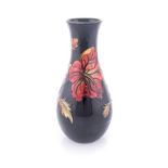 A WILLIAM MOORCROFT FLAMBE ‘HIBISCUS’ PATTERN VASE, 20TH CENTURY of tapering ovoid form with