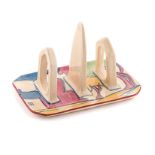 A CLARICE CLIFF ‘PASTEL AUTUMN’ PATTERN TOAST RACK, 1929 – 1934 the exterior painted with sinuous