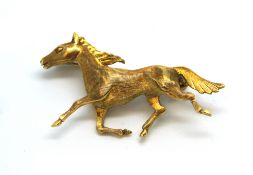 Yellow metal horse brooch