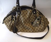 A Gucci 'Sukey' monogram canvas handbag, serial number 223974, with Gucci Pug key charm, 35cm wide