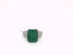 Emerald and diamond ring, rectangular step cut emerald weighing an estimated 7.06cts, with three row