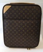 A Louis Vuitton Pegase suitcase on wheels, circa 2009, monogram canvas with vachetta leather trim,