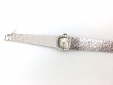 18ct vintage Tissot diamond cocktail wristwatch, plain dial with diamond bezel, 11mm case integrated