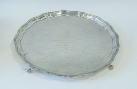 A silver salver on four ball and claw feet by Baker Brothers Silver Ltd hallmarked Birmingham