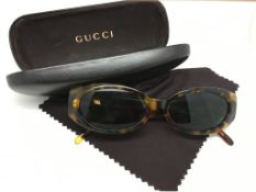 Ladies Gucci sunglasses, tortoise shell effect frames, numbered GG2196/S, with case and Gucci wipe