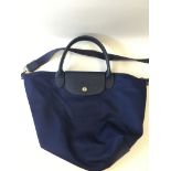 A Longchamp pliage small tote, navy blue canvas with blue leather details and detachable grosgrain