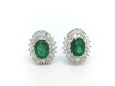 Emerald and diamond cluster earrings, central oval cut emeralds weighing an estimated total of 6.