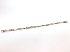 Diamond set line bracelet, each oval link set with graduating baguette cut diamonds, each link