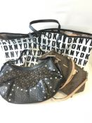 Three DKNY handbags: a shoulder bag with matching pochette printed with letters on a white ground, a