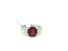 Three stone ruby and diamond ring, oval cut ruby weighing an estimated 1.99ct, with a princess cut