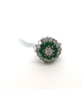 Emerald and diamond ballerina ring, central round brilliant cut diamond, surrounded by round cut