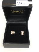 Diamond cluster earrings, central round brilliant cut diamond, within a diamond set halo surround,