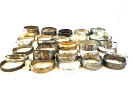 A large silver bangles including Victorian and Edwardian examples, Approximately 884g gross