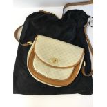 A vintage Gucci waxed monogram canvas and tan leather shoulder bag, the reverse of the inside tab
