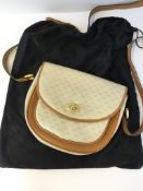 A vintage Gucci waxed monogram canvas and tan leather shoulder bag, the reverse of the inside tab