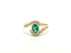 Synthetic emerald and diamond cross over ring