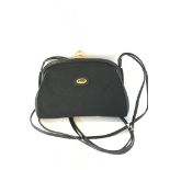A vintage Gucci monogram canvas and black leather shoulder bag with hinged clasp closure, the inside