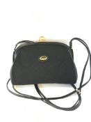 A vintage Gucci monogram canvas and black leather shoulder bag with hinged clasp closure, the inside