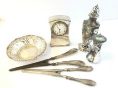 A selection of silver items, including a clock and pierced bon bon dish, gross weight