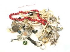 A bag of costume jewellery, Including silver brooches, charms and bead necklaces, gross weight