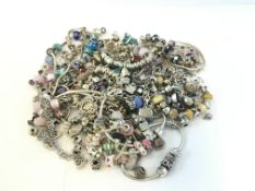 A quantity of mostly modern charm bracelets including glass bead charms, Charmillia, Rhonda