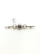 Amethyst and seed pearl bar brooch, oval cut amethyst, approximately 55cm long, stamped 15ct,