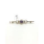 Amethyst and seed pearl bar brooch, oval cut amethyst, approximately 55cm long, stamped 15ct,