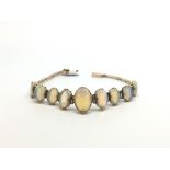 Graduated Opal bracelet, nine cabochon cut opals from approximately13x9mm to 9x6.5mm, double claw