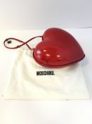 A Moschino â€œLoveâ€ heart shaped evening bag, the moulded bag covered in red shiny material, the