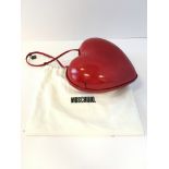 A Moschino â€œLoveâ€ heart shaped evening bag, the moulded bag covered in red shiny material, the