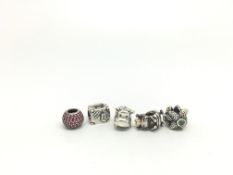 Pandora 5x charms including; pink stone set bead, blue stone set star fish, cow