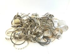 A quantity of mostly silver antique bangles and cuffs, approximately 1976g gross