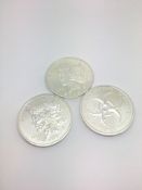 Three silver coins marked 'Zombucks currency of the Apocalypse 1oz 999.9 fine silver'