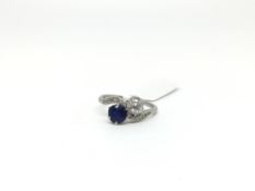 Sapphire and diamond two stone cross over ring, old cut diamond claw set with a 5.9mm round cut