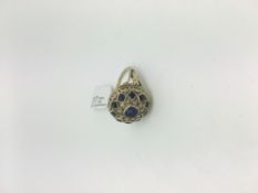 Sapphire set locket ring, centre cushion cut sapphire approximately 5.5mm, mounted in a floral