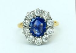 Sapphire and diamond cluster ring, central oval cut sapphire weighing an estimated 1.20cts,