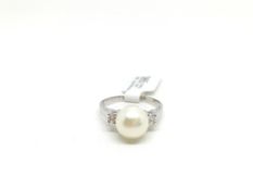 Pearl and diamond ring, central 8.5mm pearl set with a single diamond to each side, estimated