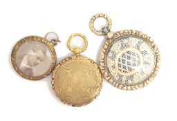 Three Victorian yellow metal mourning lockets, two gilt metal and one testing as 9ct