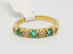 Emerald and diamond half eternity ring, alternating round cut emeralds and illusion set Swiss cut