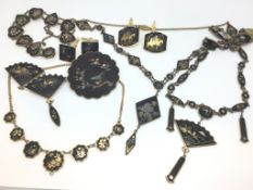 Large quantity of black lacquer gilt jewellery including necklaces, cufflinks and a brooch