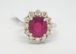 Ruby and diamond cluster ring, central oval cut ruby weighing an estimated 3.95cts, surrounded by